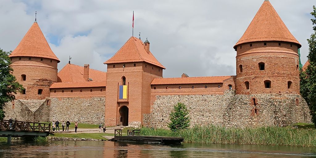 A large brick building sitting next to a body of water