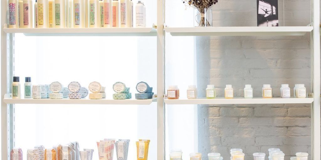 Shelves displaying assorted beauty products in a bright, clean store.