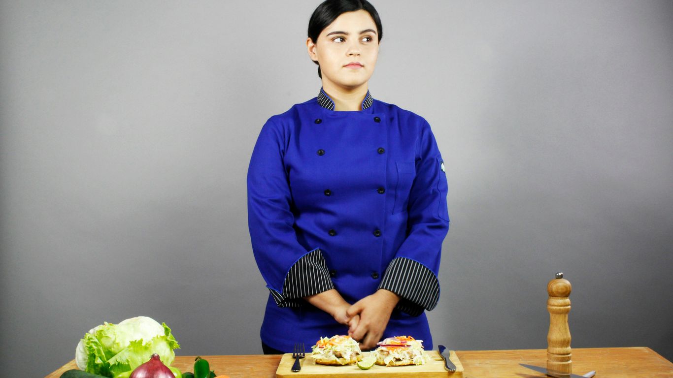 woman in blue dress shirt sitting on chair