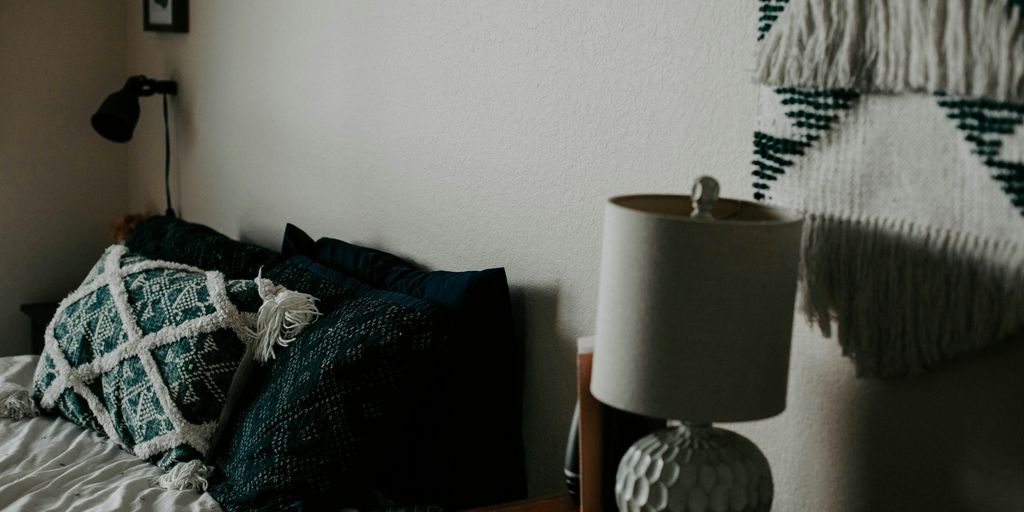 white table lamp on wooden side table