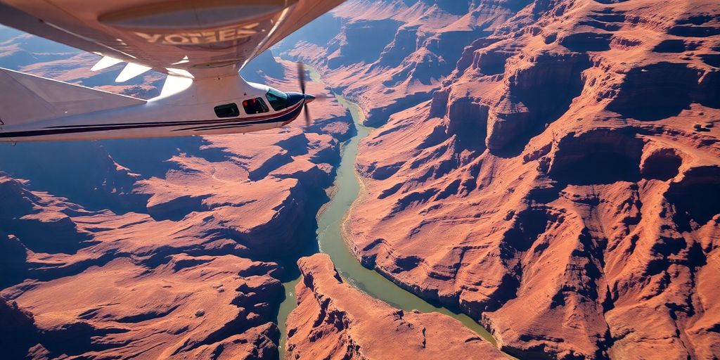 A small tour airplane flying over the Grand Canyon.