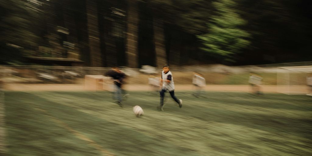 A blurry photo of a group of people playing soccer