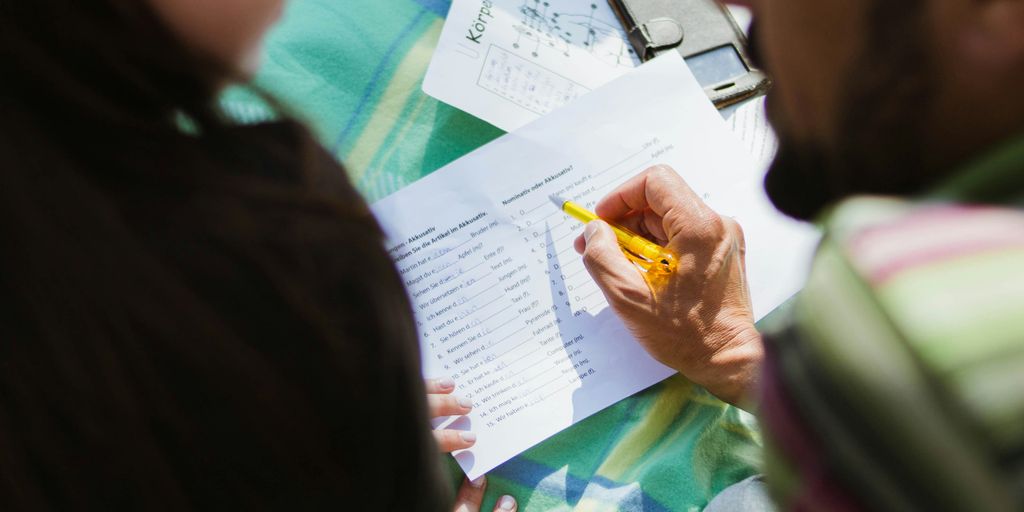 man in black shirt sitting beside woman in gray shirt