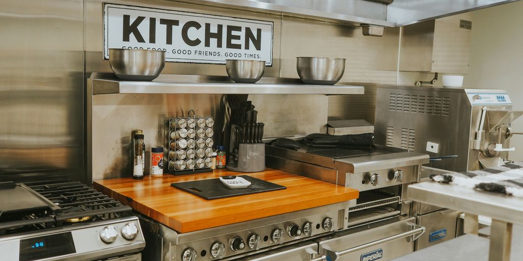 a kitchen with stainless steel appliances and a wooden counter