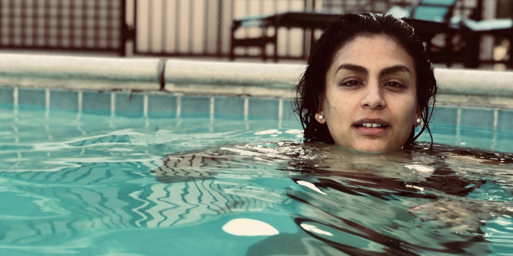 swimmer drinking recovery drink poolside