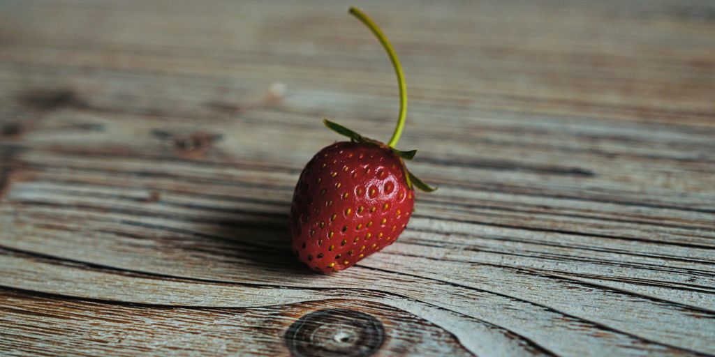 strawberry on wooden surface