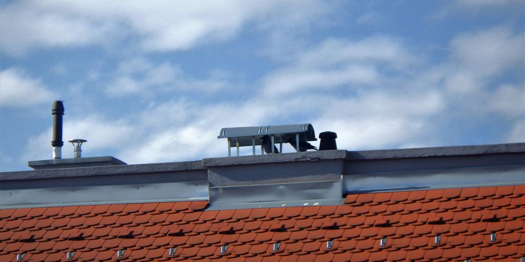 the roof of a building with a couple of chimneys