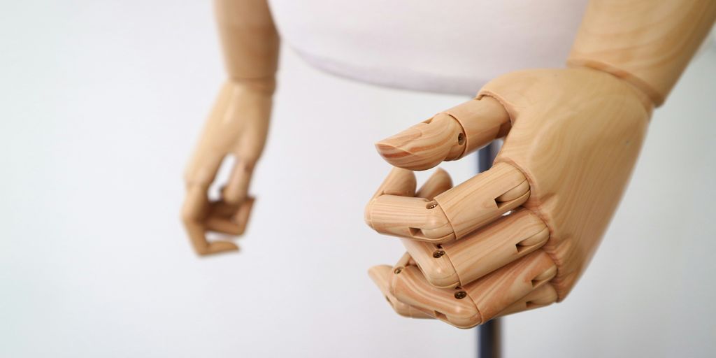 shallow focus photography of brown wooden puppet