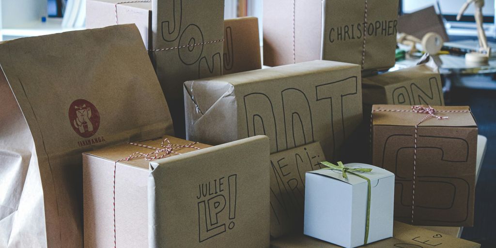 a pile of brown paper bags sitting on top of a table