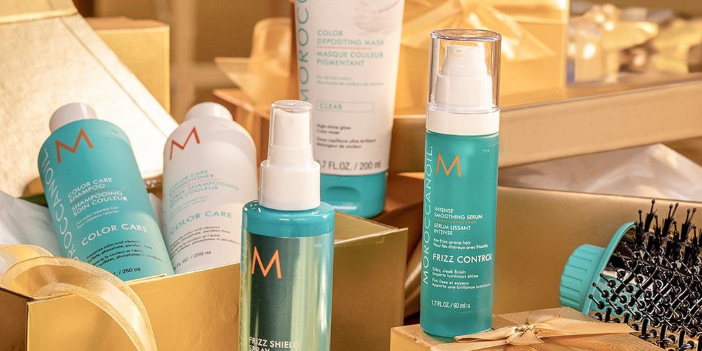 Assorted hair care products displayed with golden gift boxes.