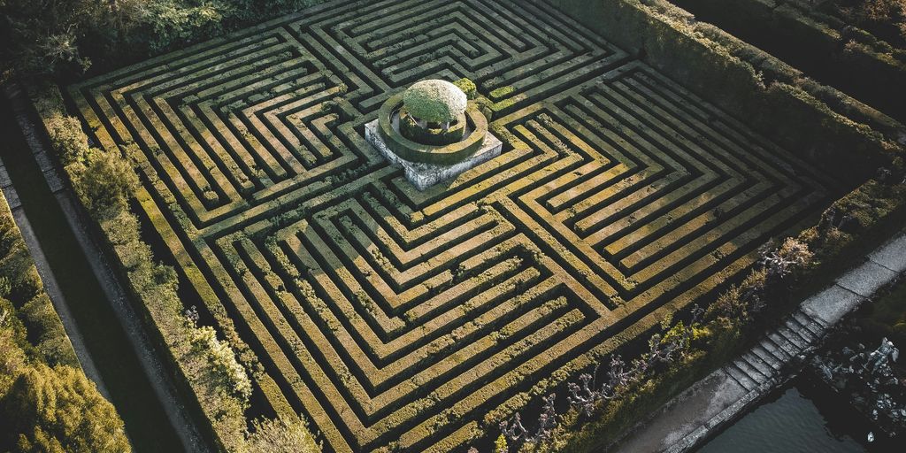 A hedgerow maze with a central feature.