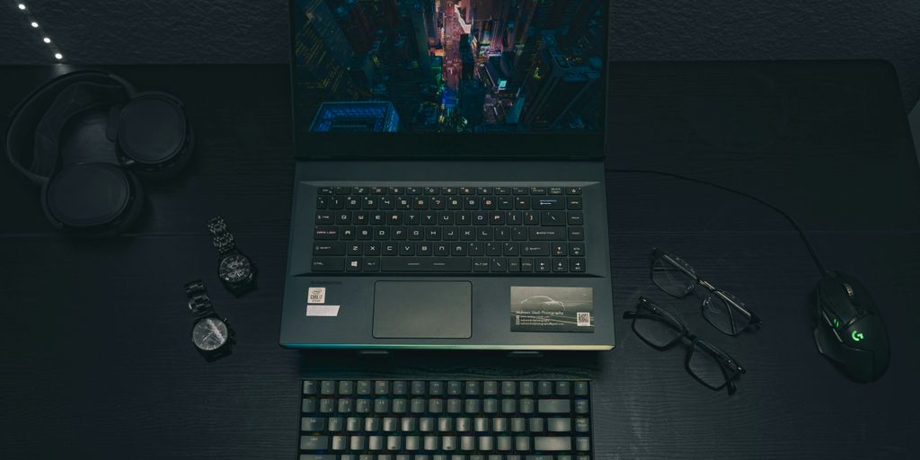 a laptop computer sitting on top of a wooden desk