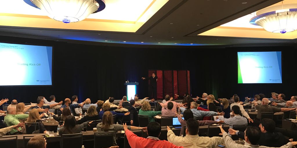 A conference setting, with attendees engaged and participating actively.