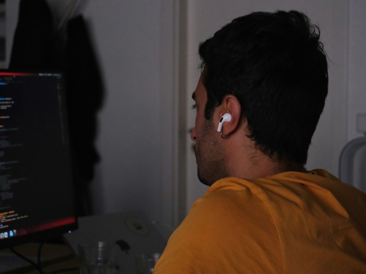 A man sitting in front of a computer monitor