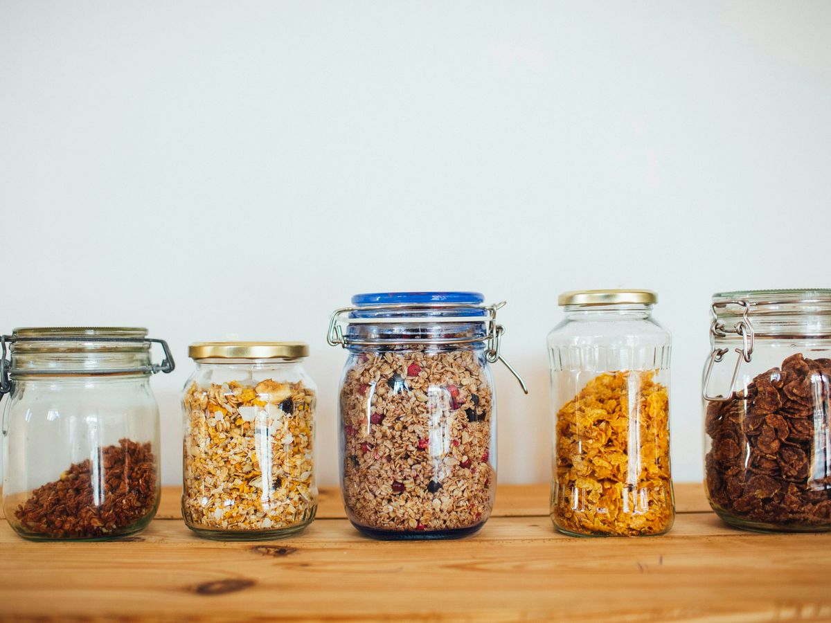 two clear glass jars with brown and black beads