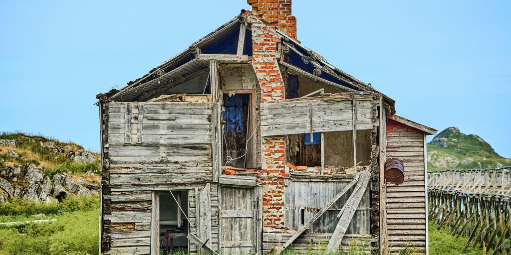 an old run down house with a broken window
