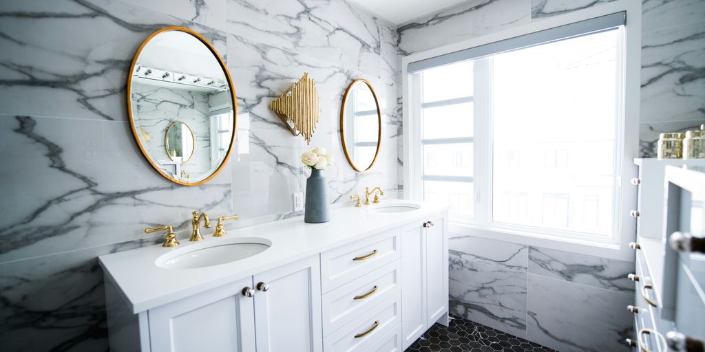 a bathroom with two sinks and a large mirror