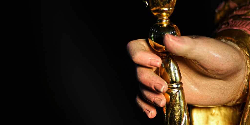 A close up of a person holding a golden object