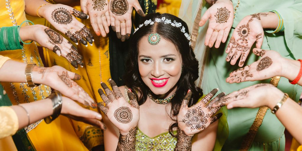a woman in a green dress is surrounded by henna's