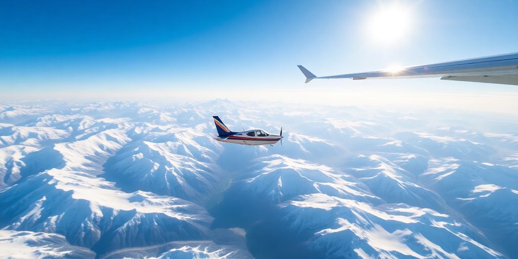 A small airplane flies over vast, snow-covered mountain peaks.