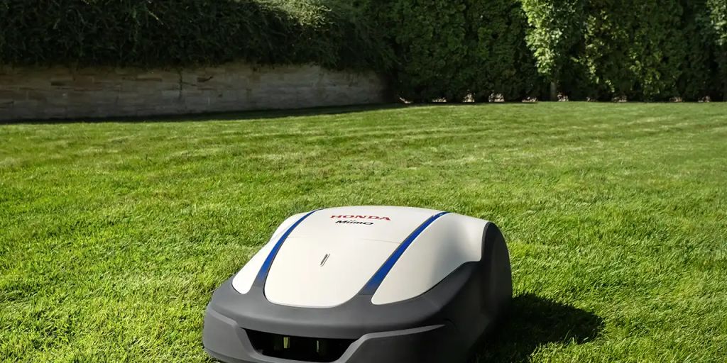 Robotic mower working on a well-groomed lawn.