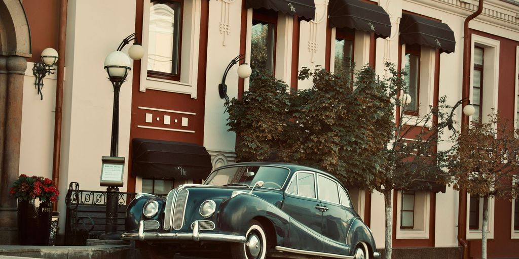 vintage green coupe parking near house