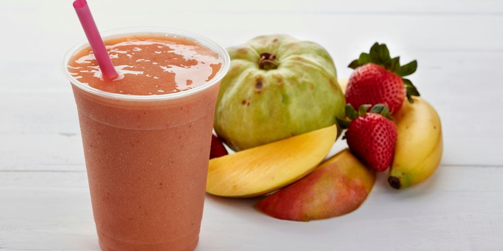 a smoothie with strawberries, apples, and bananas