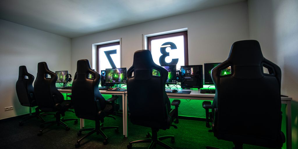 black office rolling chair near black flat screen computer monitor