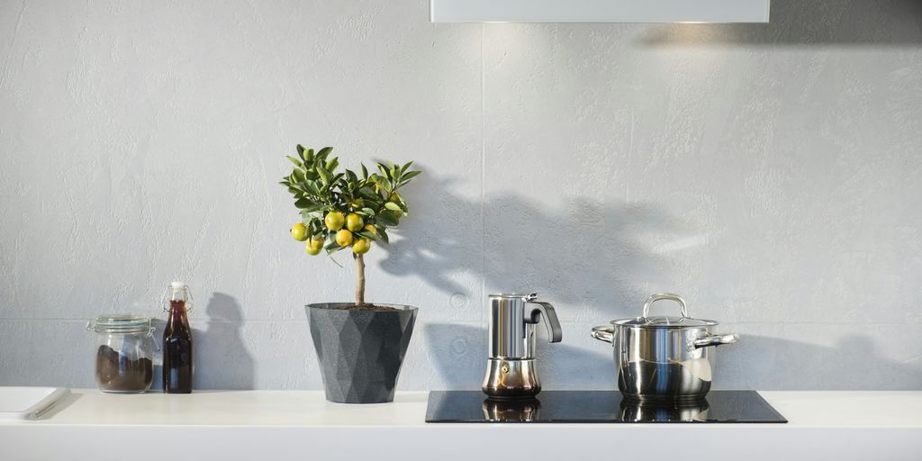 silver pot on top of induction oven