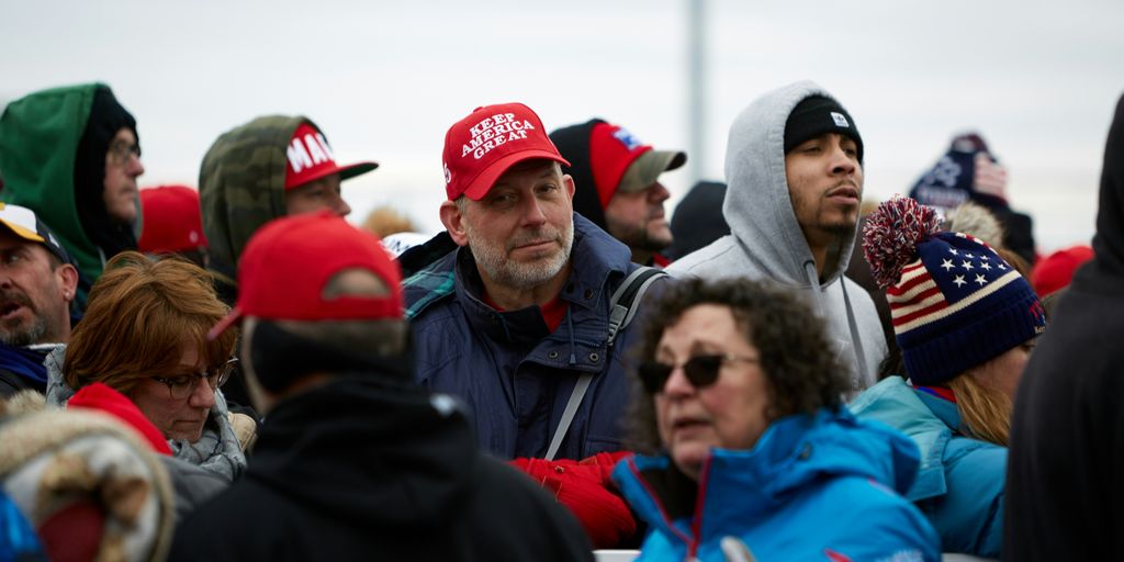 group of people in red cap and blue jacket