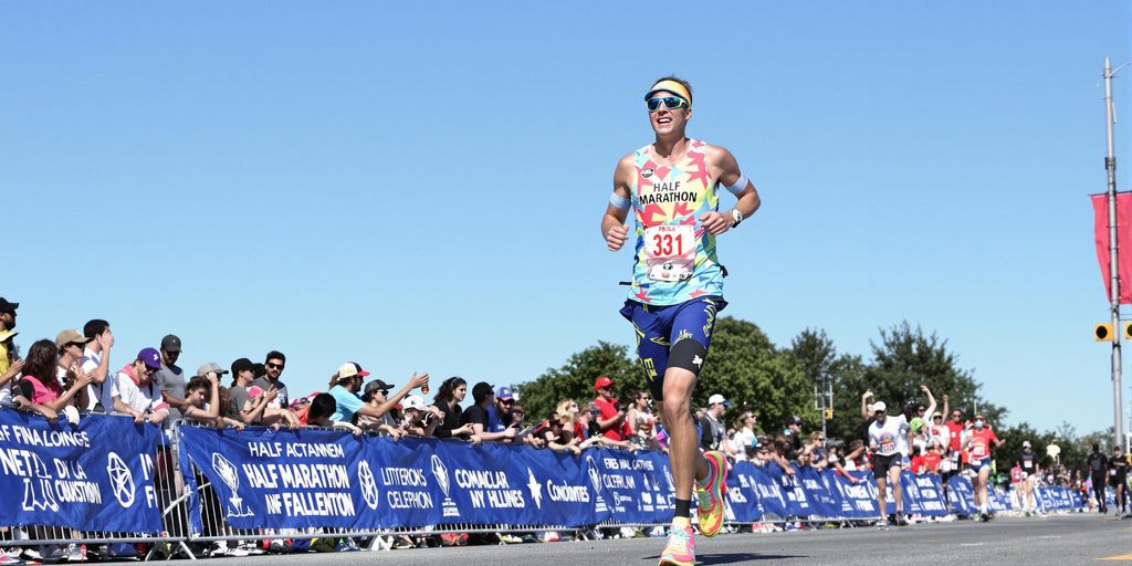 Runner in vibrant gear nearing the finish line.