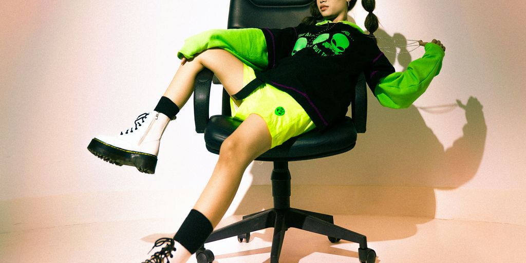 man in green and black jacket sitting on black office rolling chair