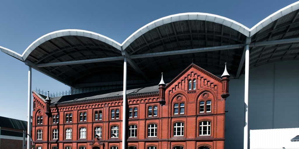A large red brick building sitting next to a parking lot