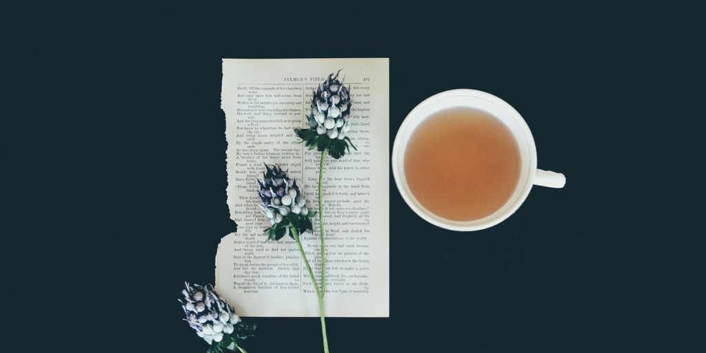 white ceramic tea cup beside white flowers