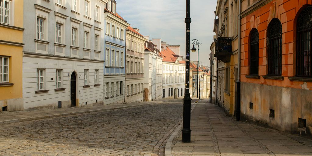 A cobblestone street with colorful buildings.