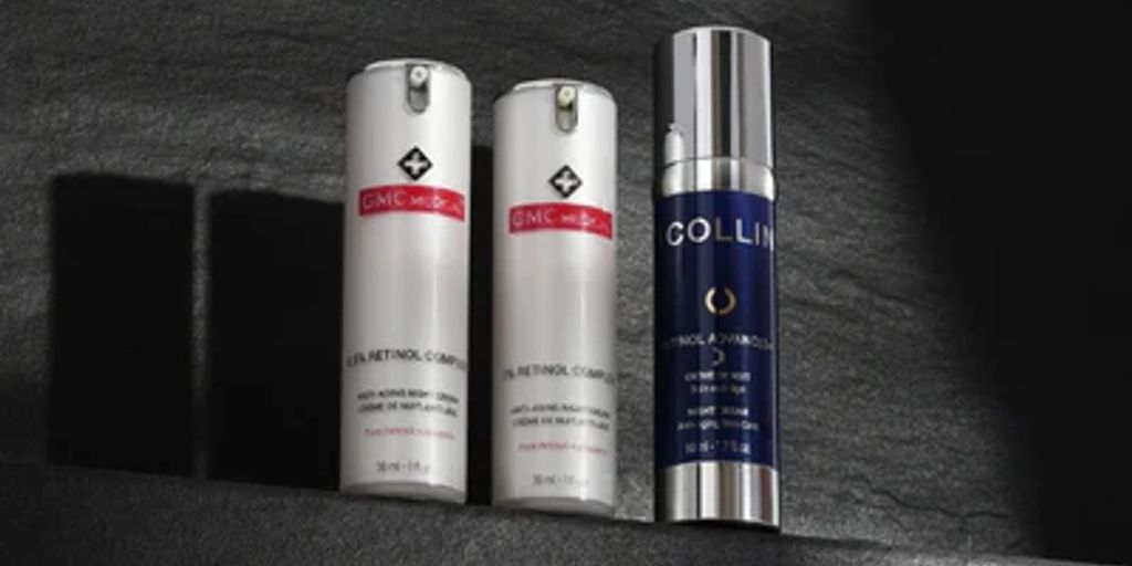 Three skincare product bottles casting shadows on textured surface.