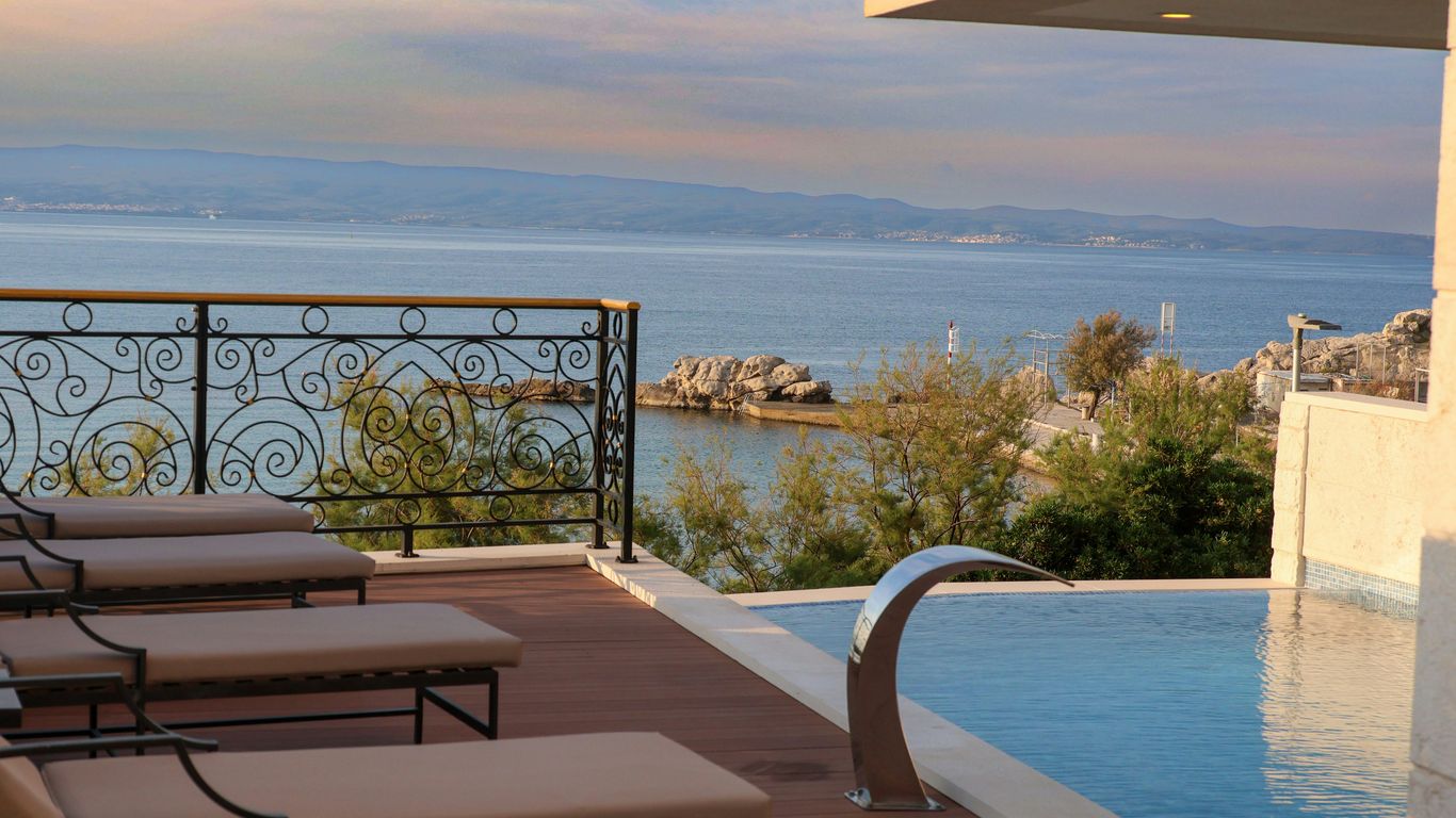 a couple of lounge chairs sitting next to a swimming pool