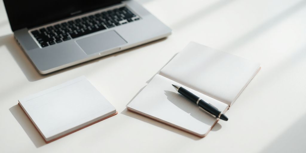 Laptop, notebook, and pen on a clean desk