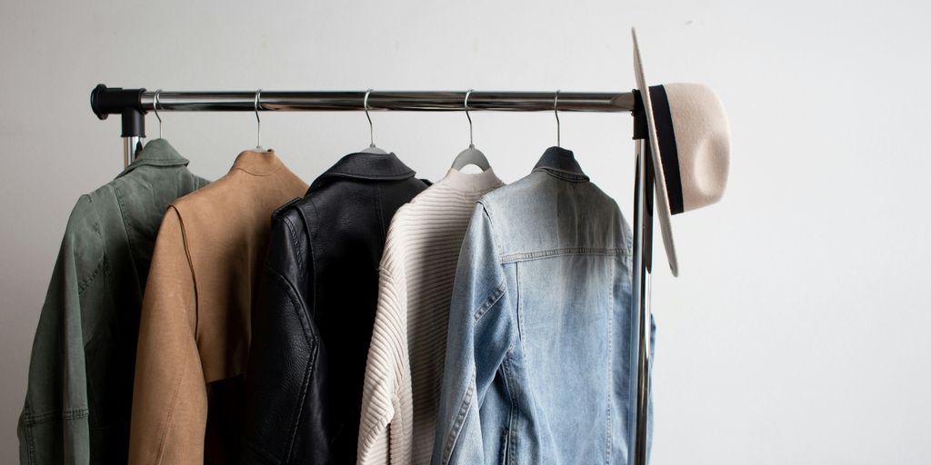 one cowboy hat and five jackets hanged on clothes rack