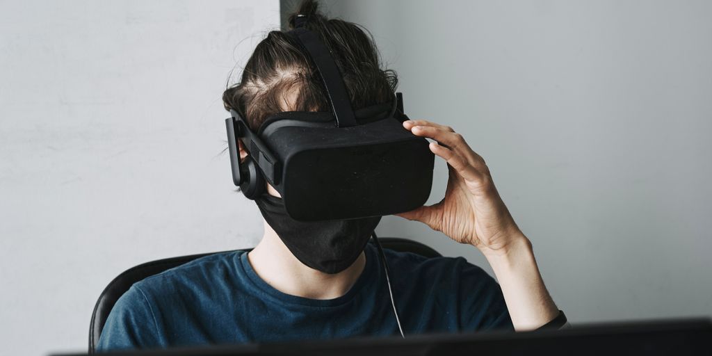 man in blue crew neck shirt wearing black vr goggles