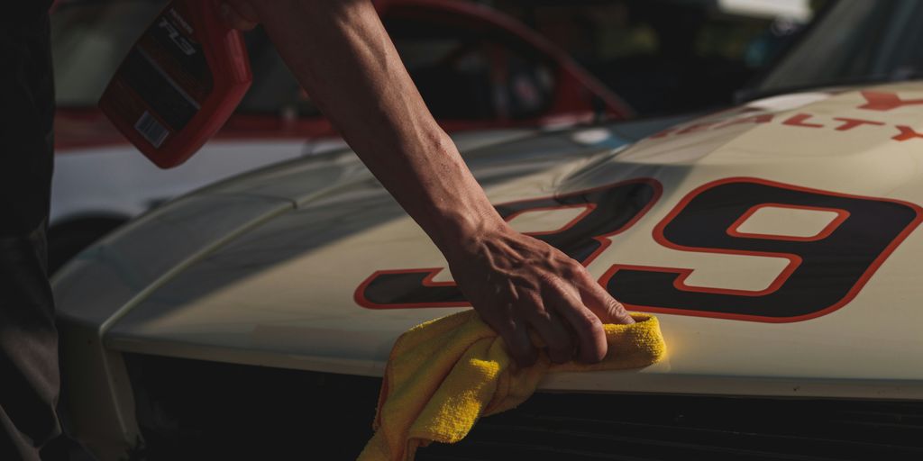 closeup photo of person wiping white racing card