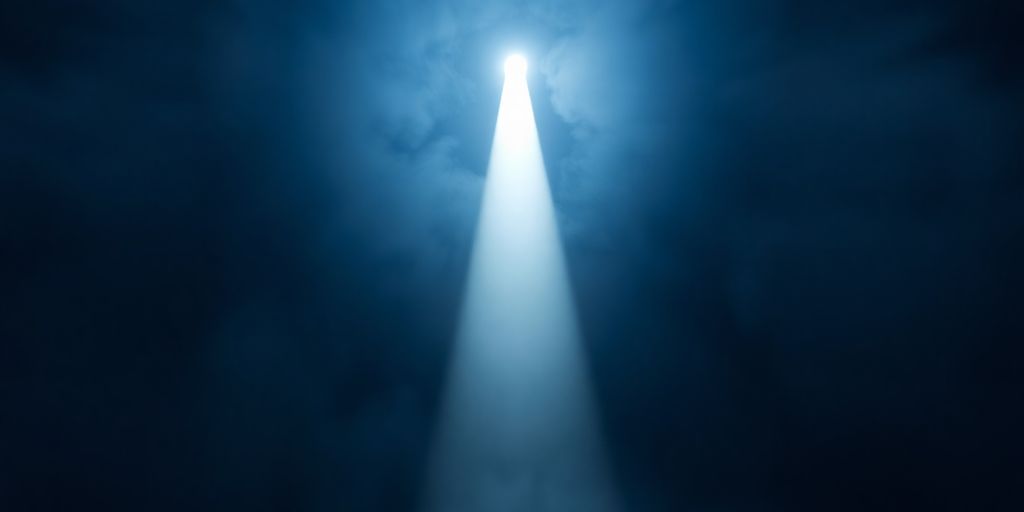 A single bright light piercing through a dense fog.