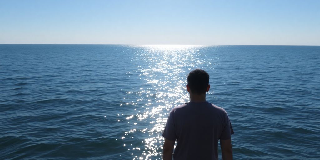 Person looking thoughtfully at a calm sea.