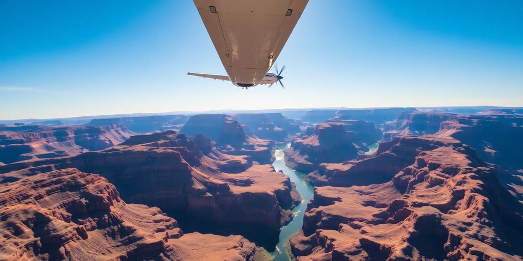 Small airplane flying over the vast Grand Canyon.