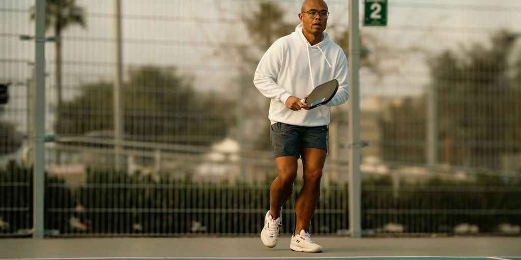 A man standing on a tennis court holding a racquet