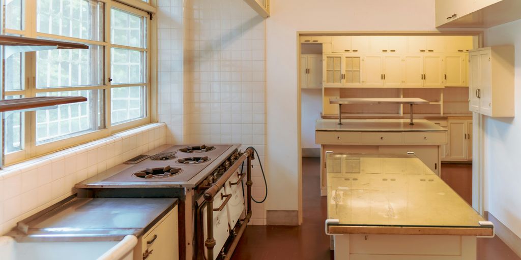 a kitchen with a stove top oven next to a window