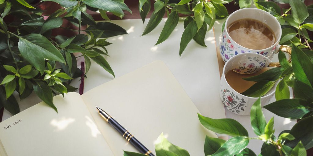 A peaceful workspace with a journal and tea.
