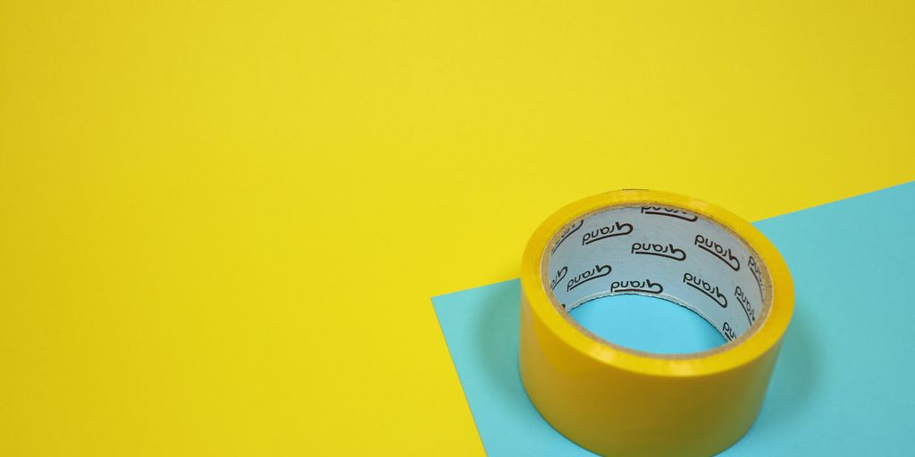 yellow duct tape on blue surface