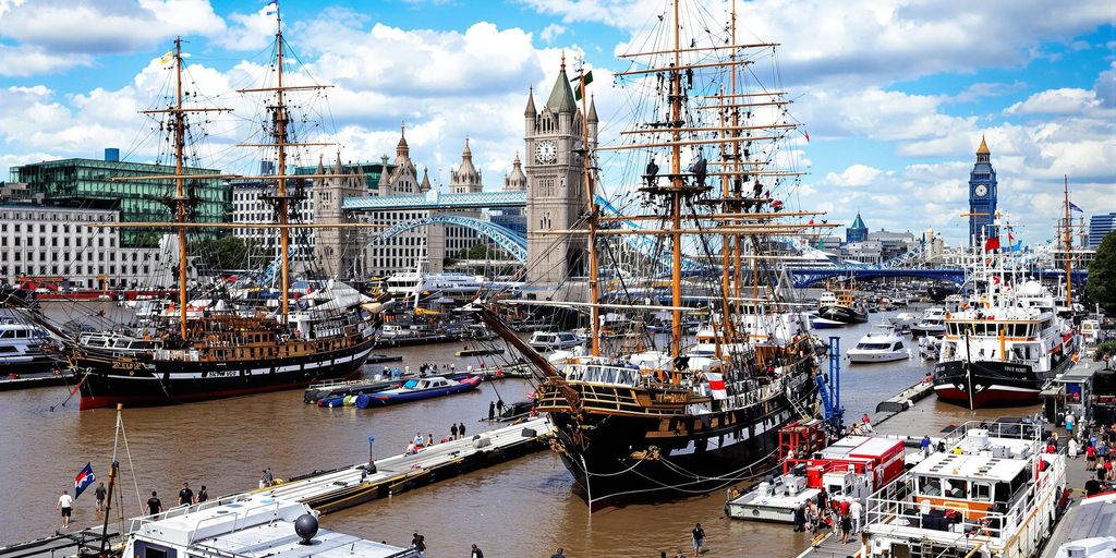 London waterfront with historic ships and modern vessels.