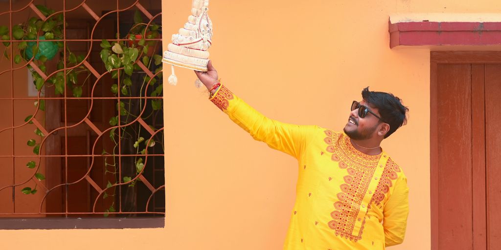 A man in a yellow outfit holding a white object